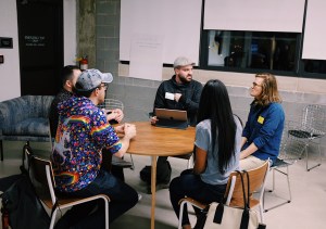 People sitting a circular table talking