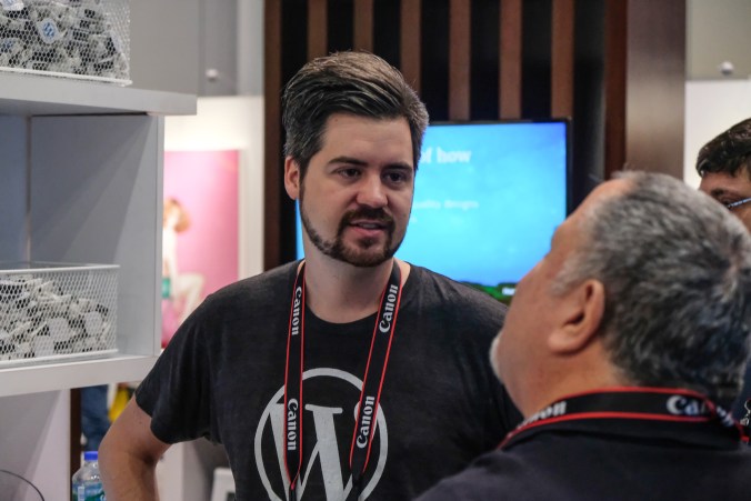 Dennis, an engineer, listens to a photographer as he talks about his current website platform