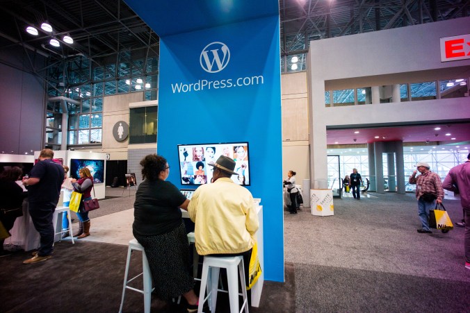 Michelle, a happiness engineer, sits down with a photographer to discuss features of his website